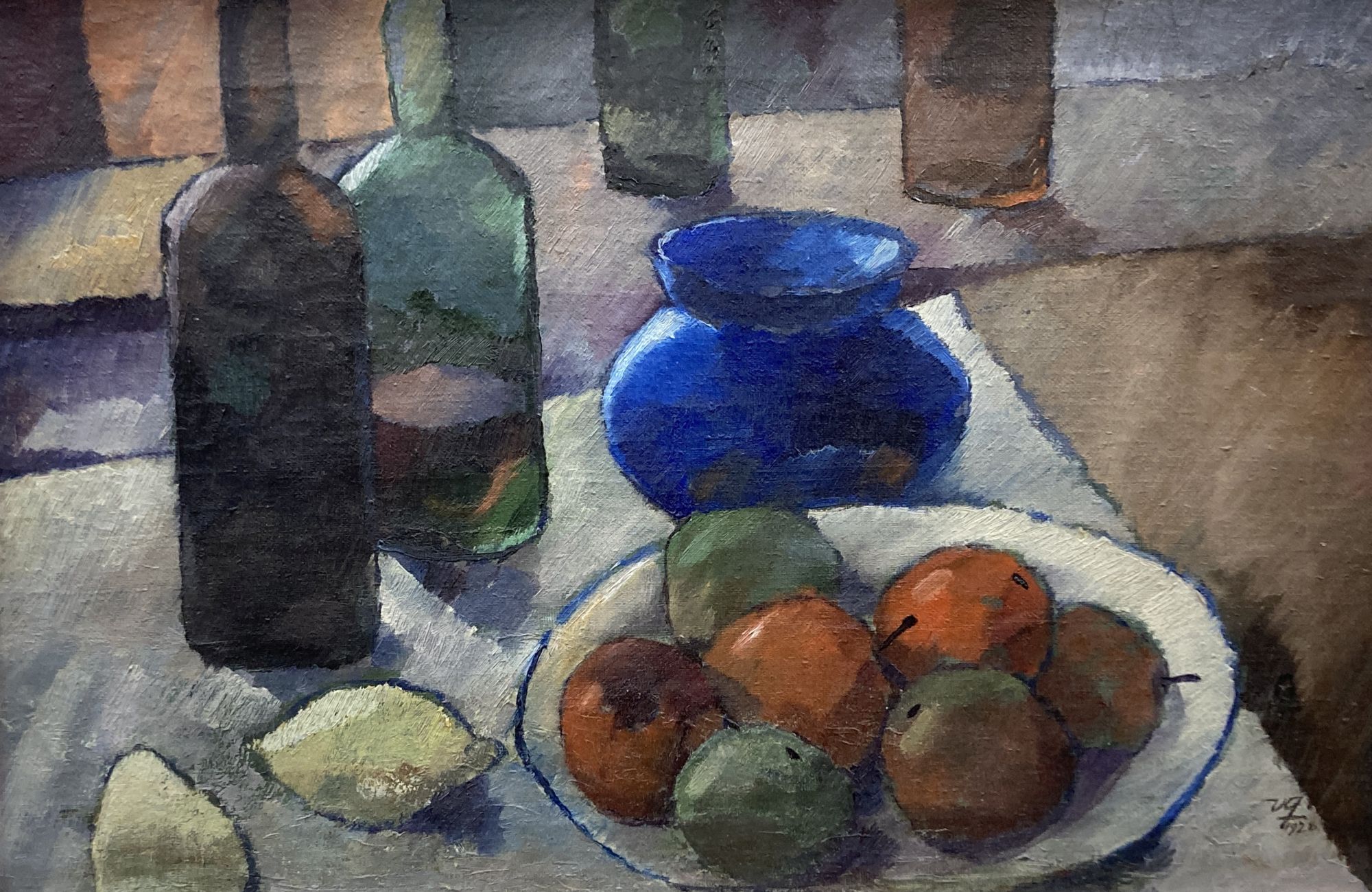 French School c.1928, oil on canvas, Still life of fruit and bottles on a table top, initialled and dated 1928, 39 x 60cm